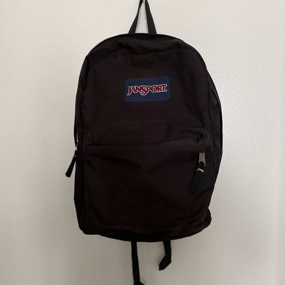 Jansport Backpack: Black with front pocket and adjustable straps
